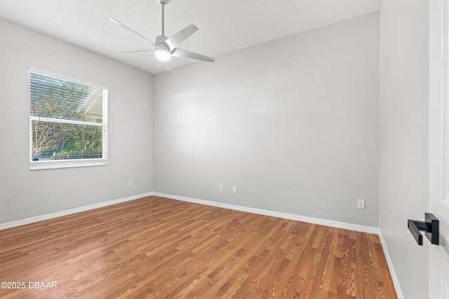 empty room with hardwood / wood-style flooring, ceiling fan, and a textured ceiling