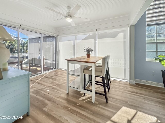 sunroom / solarium with a ceiling fan