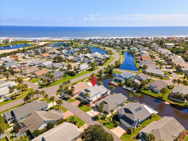 drone / aerial view featuring a water view and a residential view