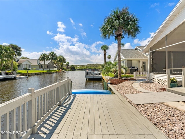 dock area with a water view and a residential view