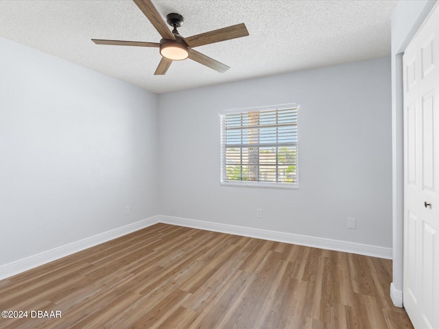 spare room with light wood-style floors and baseboards