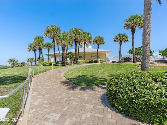 view of community featuring fence and a lawn