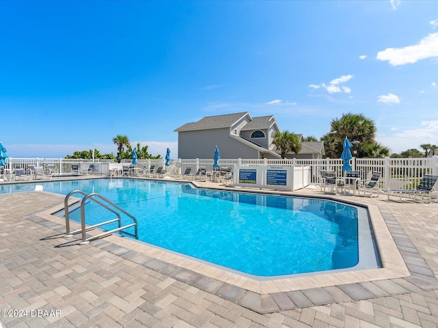 community pool featuring a patio area and fence