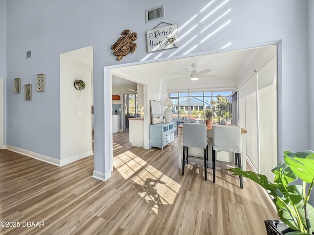 kitchen featuring light wood-style floors, a sunroom, visible vents, and ceiling fan