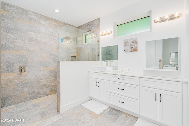 bathroom with vanity and tiled shower