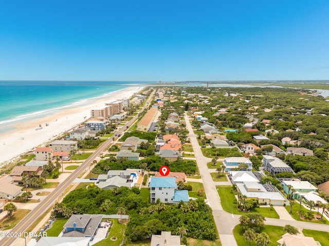 bird's eye view featuring a water view and a beach view