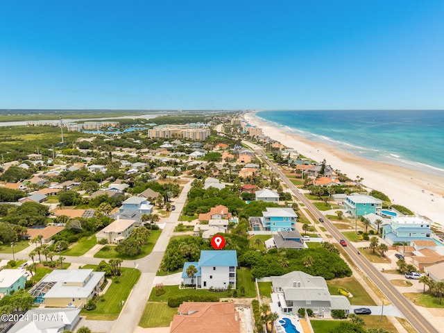 aerial view with a water view and a beach view