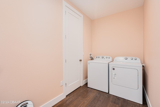 washroom with dark hardwood / wood-style flooring and washing machine and dryer