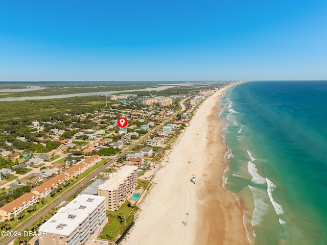 drone / aerial view with a water view and a beach view