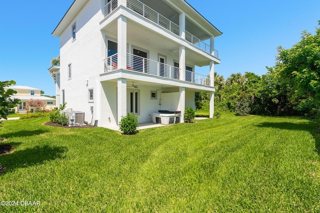 4727 Riverglen Blvd, Ponce Inlet, FL 32127 - back of house with a lawn, ceiling fan, stucco siding, and a balcony