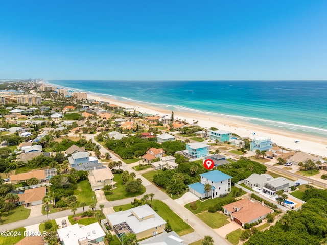 bird's eye view featuring a water view and a beach view