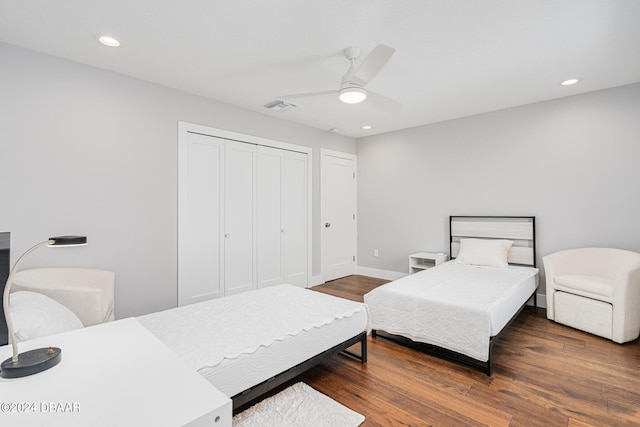 bedroom with ceiling fan, dark hardwood / wood-style flooring, and a closet