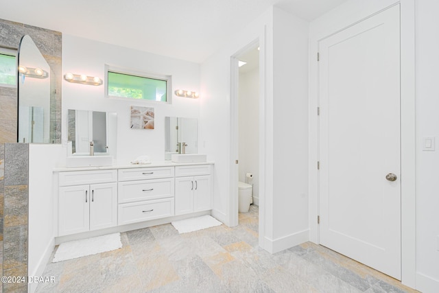 bathroom featuring vanity and toilet