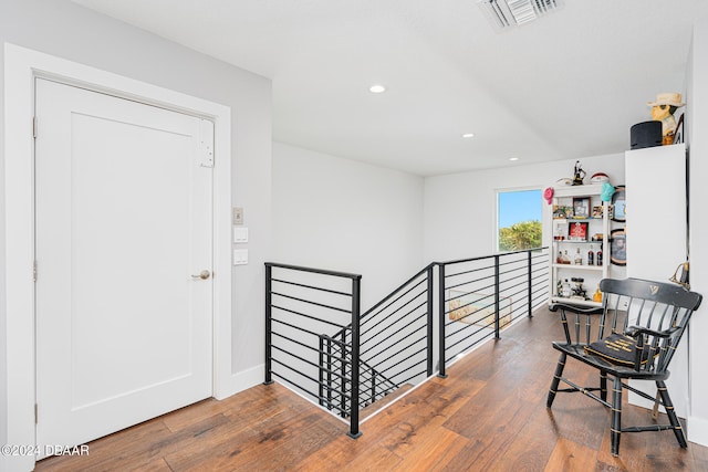 hallway with hardwood / wood-style floors