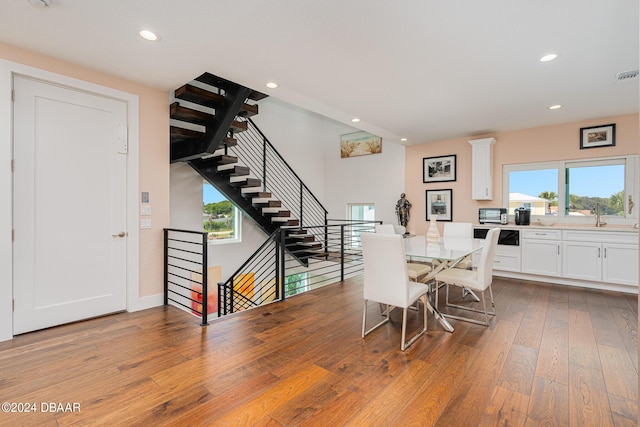 4727 Riverglen Blvd, Ponce Inlet, FL 32127 - dining space featuring wood-type flooring, plenty of natural light, recessed lighting, and stairs