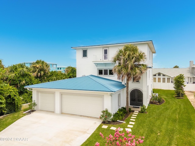 4727 Riverglen Blvd, Ponce Inlet, FL 32127 - view of front facade featuring a balcony, a front lawn, stucco siding, driveway, and a garage