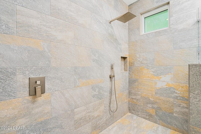 bathroom featuring vanity and a tile shower