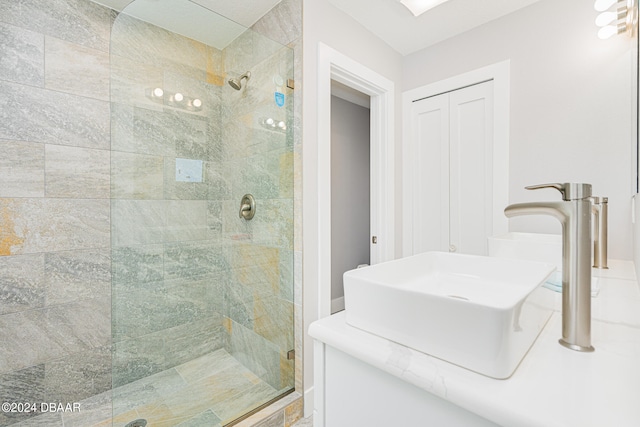 bathroom featuring sink and a shower with door