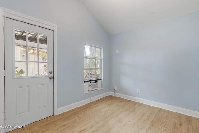 interior space with vaulted ceiling and light hardwood / wood-style flooring