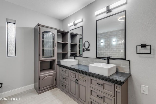 bathroom featuring tasteful backsplash and vanity