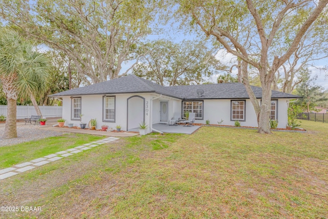 single story home featuring a front yard and a patio