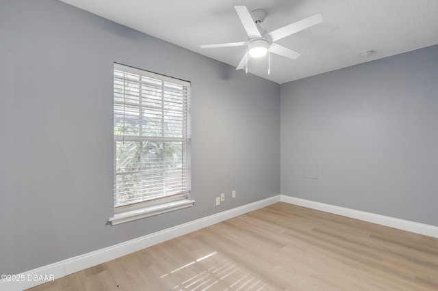 empty room with light wood-type flooring and ceiling fan