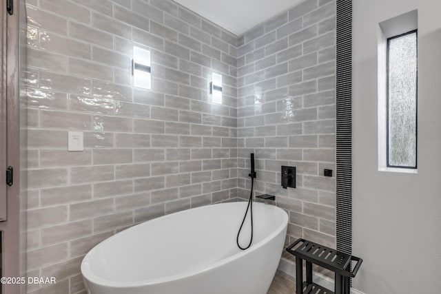 bathroom with tile walls and a bathtub