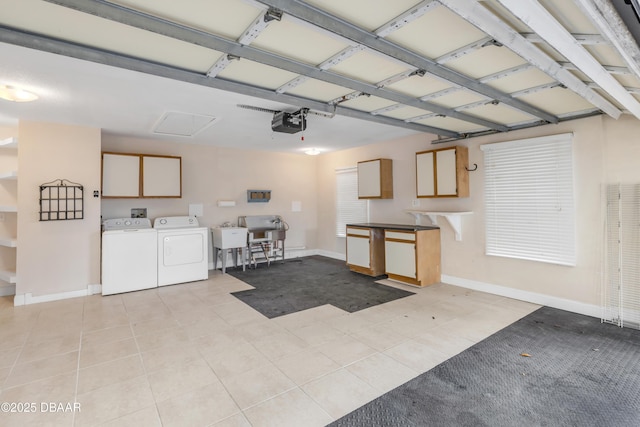 garage with separate washer and dryer, a garage door opener, and sink