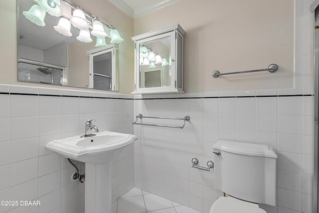 bathroom featuring toilet, tile walls, ornamental molding, and a shower with shower door