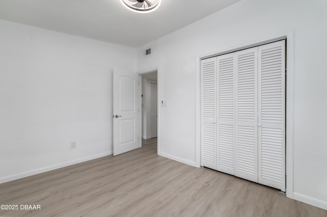 619 Aberdeen St, Daytona Beach, FL 32114 - unfurnished bedroom with wood finished floors, a closet, and baseboards