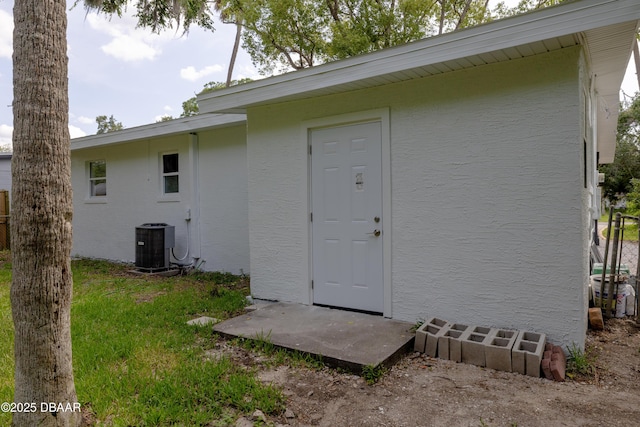 619 Aberdeen St, Daytona Beach, FL 32114 - back of house featuring central air condition unit and stucco siding