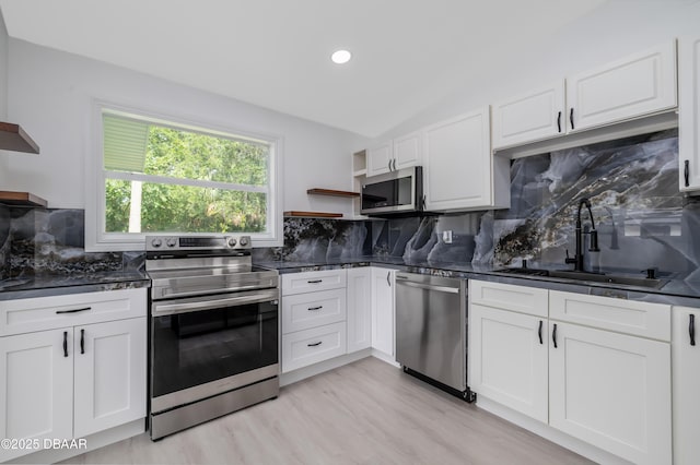 619 Aberdeen St, Daytona Beach, FL 32114 - kitchen with appliances with stainless steel finishes, open shelves, dark countertops, and recessed lighting