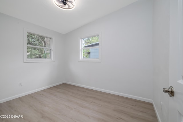 619 Aberdeen St, Daytona Beach, FL 32114 - spare room featuring light wood-type flooring, vaulted ceiling, and baseboards