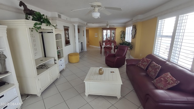 living room with ceiling fan, visible vents, decorative columns, and light tile patterned floors