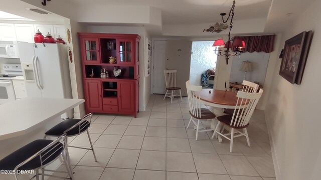 dining area with a chandelier, visible vents, and light tile patterned floors