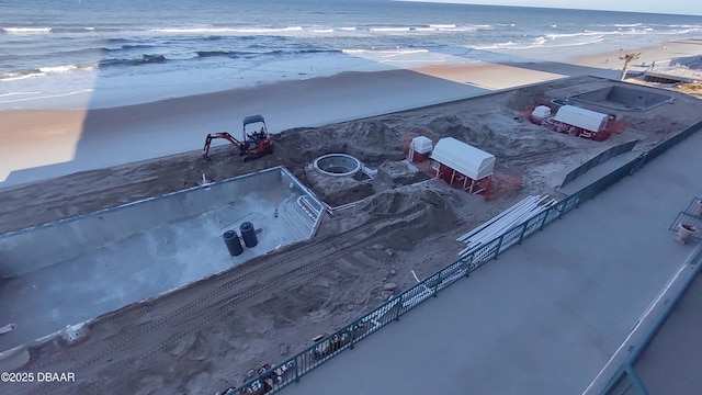 bird's eye view with a water view and a beach view