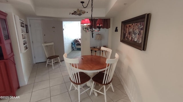 dining space with a notable chandelier, baseboards, and light tile patterned floors