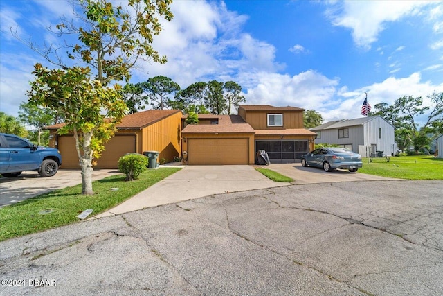 view of front of property with a garage and a front yard