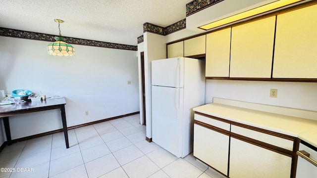 93 Hay Bale Trl, Ormond Beach, FL 32174 - kitchen featuring freestanding refrigerator, a textured ceiling, cream cabinets, and light countertops