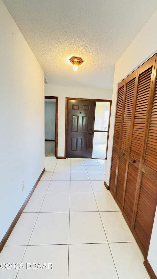93 Hay Bale Trl, Ormond Beach, FL 32174 - hall featuring baseboards, a textured ceiling, light tile patterned floors, and visible vents