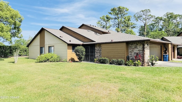 93 Hay Bale Trl, Ormond Beach, FL 32174 - view of front facade featuring a front lawn, roof with shingles, brick siding, an attached garage, and driveway