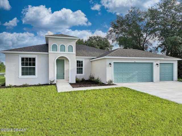 view of front of house with a garage and a front yard