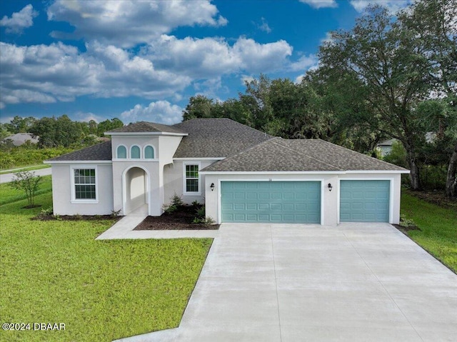 view of front of house featuring a garage and a front lawn