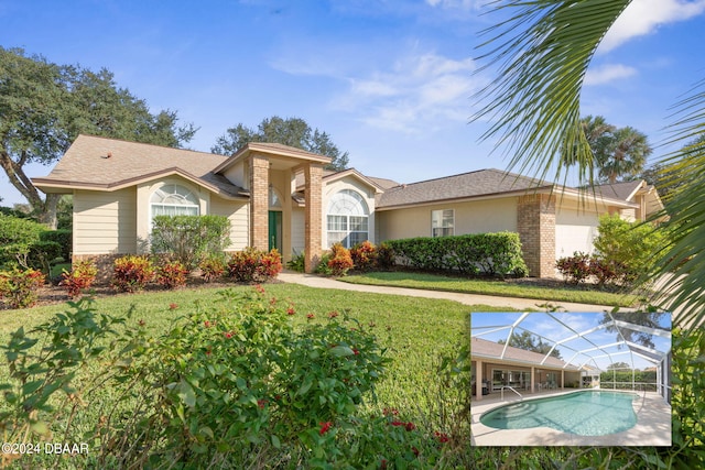 single story home featuring a garage and a front yard