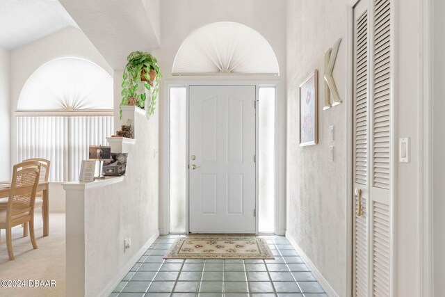 74 Kingsley Ln, Ormond Beach, FL 32174 - foyer with tile patterned floors and baseboards