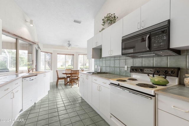 kitchen with white cabinetry, white appliances, tile patterned floors, and ceiling fan