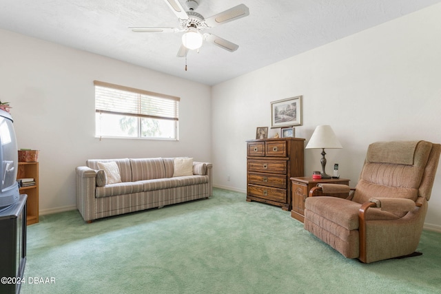 sitting room featuring ceiling fan and light colored carpet