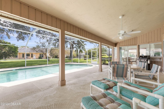 74 Kingsley Ln, Ormond Beach, FL 32174 - outdoor pool featuring a ceiling fan, a patio area, glass enclosure, and a yard
