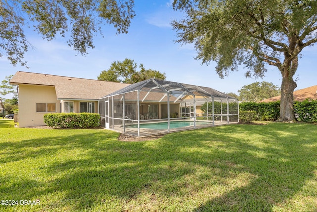 74 Kingsley Ln, Ormond Beach, FL 32174 - back of house featuring a lawn, an outdoor pool, and stucco siding