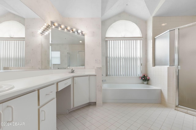 74 Kingsley Ln, Ormond Beach, FL 32174 - full bathroom with tile patterned flooring, a stall shower, a bath, double vanity, and lofted ceiling